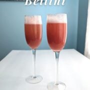 Strawberry bellinis in two champagne flutes. Text overlay reads "Strawberry Bellini. The Perfect Brunch Cocktail. Serves 6."