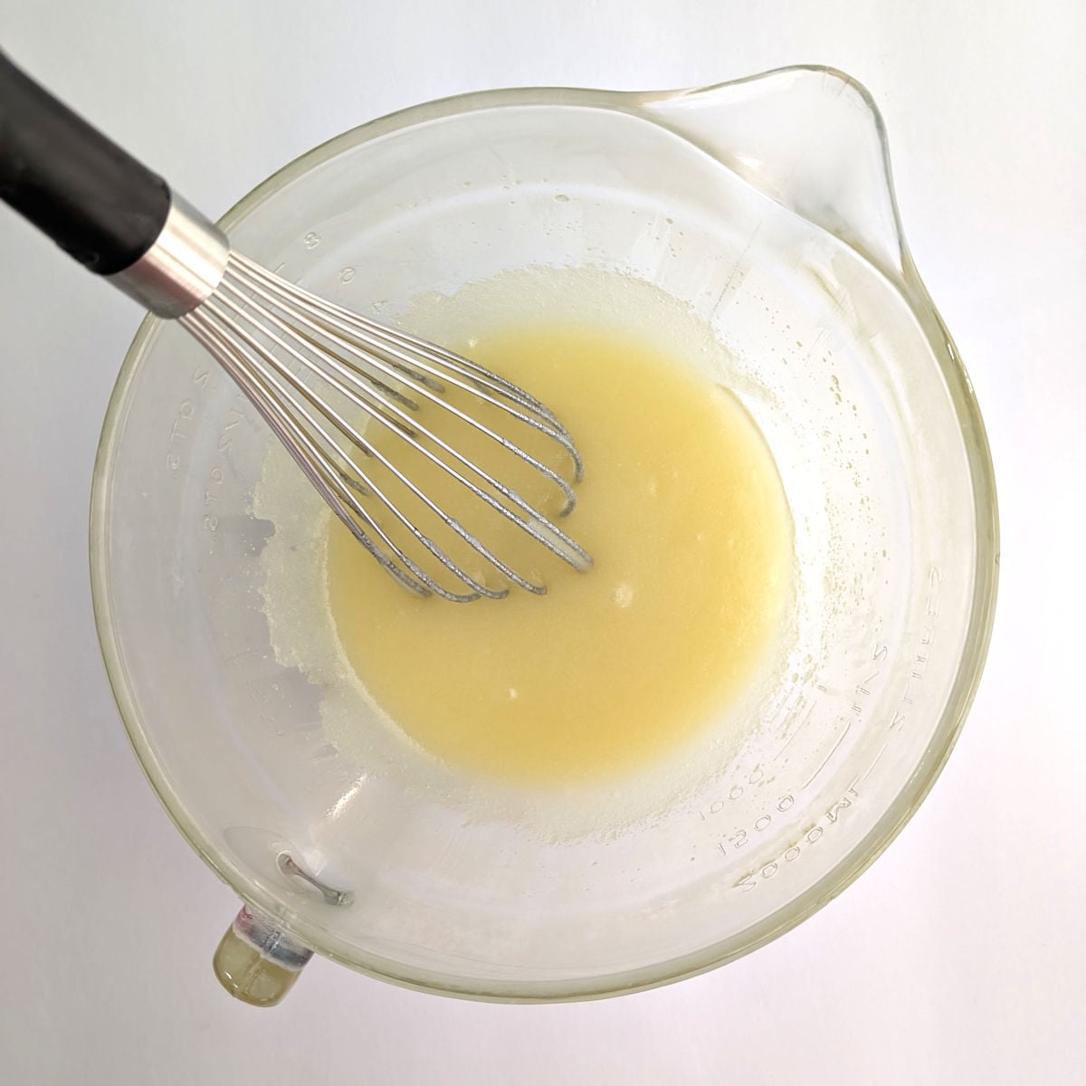 Sugar and melted butter, stirred together in an 8-cup measuring cup.