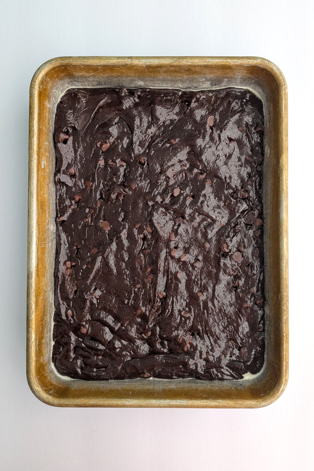 Batter for fudge brownies, in a 9x13 inch measuring pan.