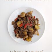 Roast beef hash with potatoes and red bell peppers on a plate. Text overlay reads "Roast Beef Hash. Leftover Roast Beef. Potatoes & Peppers. Easy As Cookies."