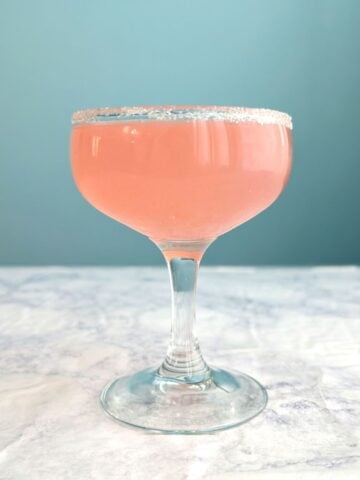 Campari margarita in a sugar-rimmed coupe glass.