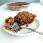 Bite of black bottom oatmeal pie on a fork, showing chocolate ganache topped with a chewy oat layer.